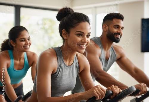 A group of people engage in a cardio workout on machines in a gym. They share the experience of a healthy lifestyle.