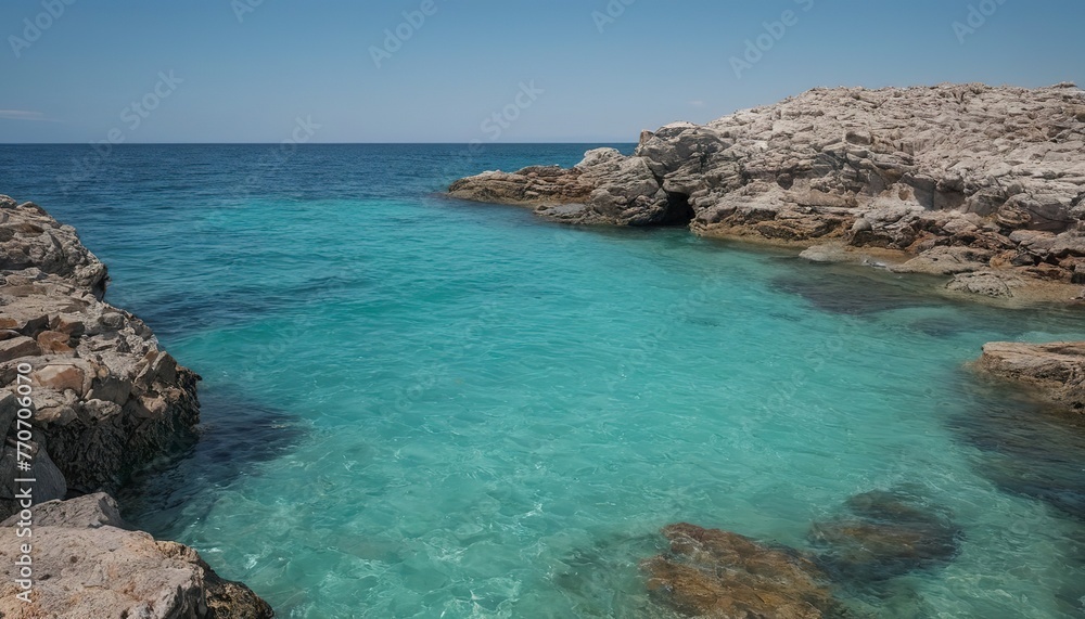 seascape with clear turquoise water among rocks and stones, in the distance you can see the horizon line