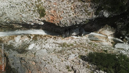 Ascending drone footage of Rinka Waterfall in the Logar Valley on a sunny day in Solcava, Slovenia photo