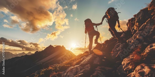 Two hikers helping each other reach the top of the mountain, a nature adventure concept on a beautiful sunrise background © Huong
