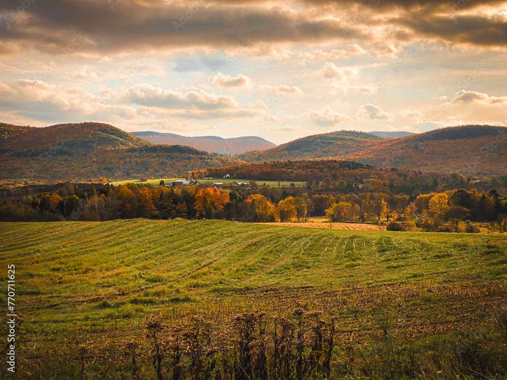 Vermont mountains and farm fields in the fall under a bright cloudy sky