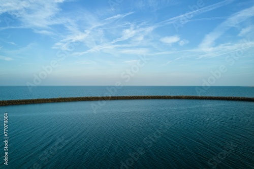Fototapeta Naklejka Na Ścianę i Meble -  Scenic landscape of a blue sea with a backdrop of white puffy clouds