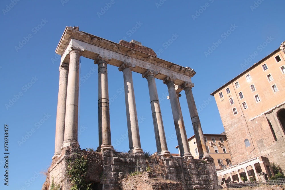 Low angle of old ruins with columns in Roman Forum in Rome, Italy
