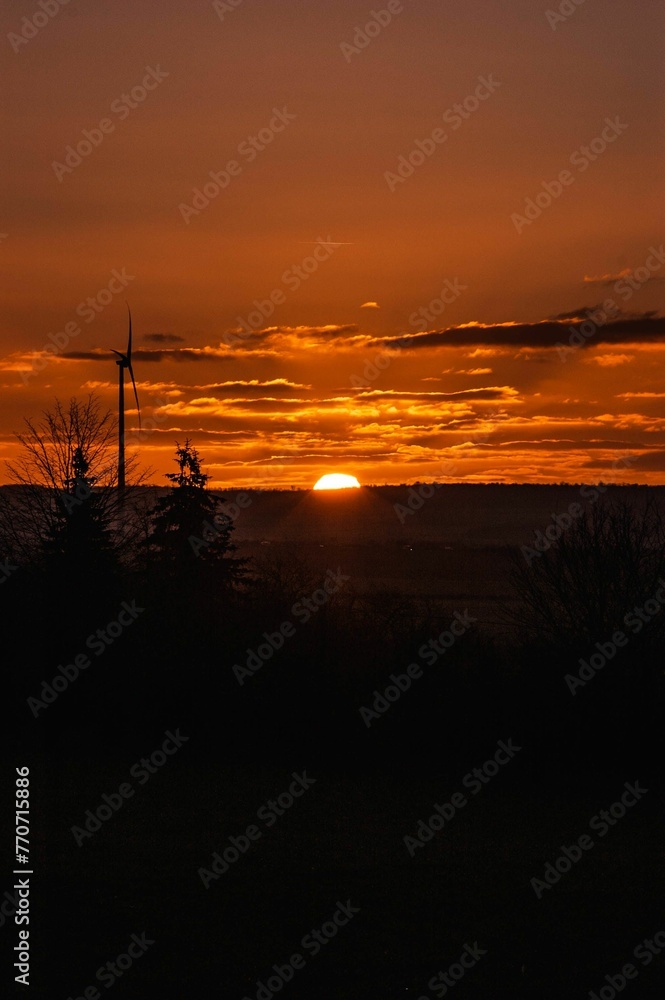 Naklejka premium High-angle shot of a vast, open landscape featuring a field and several windmills
