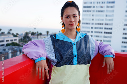 Fierce South American Woman Wearing Colorful Jacket in the Rooftop in a Late Afternoon. Escape Work Concept