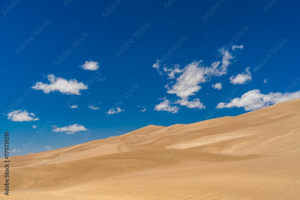 Scenic view of a desert landscape, featuring a rolling sand dune at Great Sand Dunes National Park