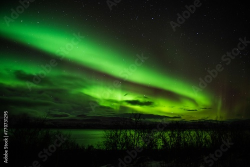 Stunning aurora borealis illuminating the night sky above the rural landscape.