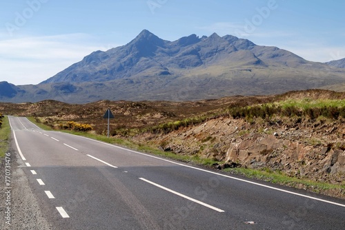 Scenic view of a long road on Skye with view of Cuillin Hills in Scottish Highlands