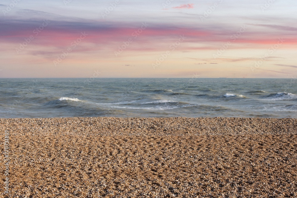 Stunning landscape of a pink and orange sunset over the horizon of the ocean Stunning landscape of a pink and orange sunset over the horizon of the ocean