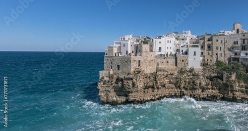 Scenic view of the Polignano a Mare coastal town, nestled beside an azure sea and dramatic cliffs