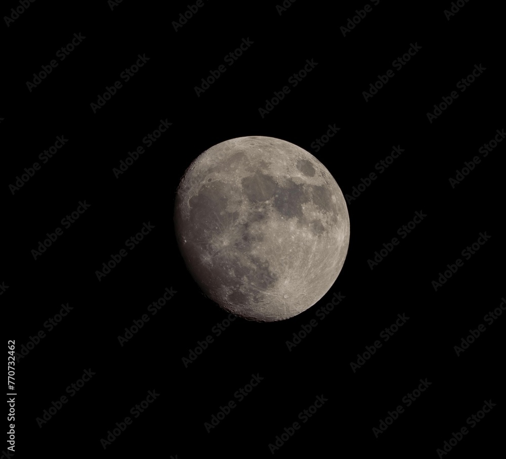 Lunar phases rising over the city in night sky Lunar phases rising over the city in night sky