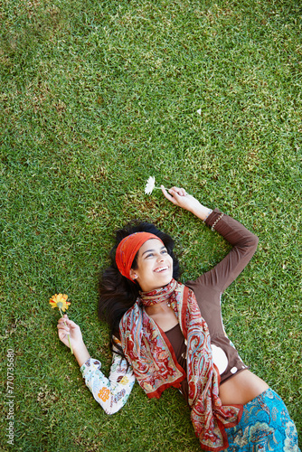 Outdoor  bohemian and woman in nature  smile and clothes with aesthetic of fashion and above. Peace  female person and girl with flower in field  summer and relax on grass with outfit for art