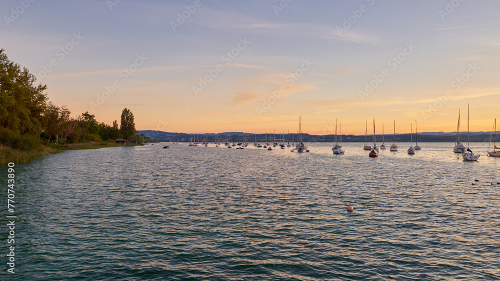 Naklejka premium Bodensee Lake Sunset Panorama. Evening Sunlight Over Tranquil Waters. Sunset Vista at Lake Bodensee in Germany.