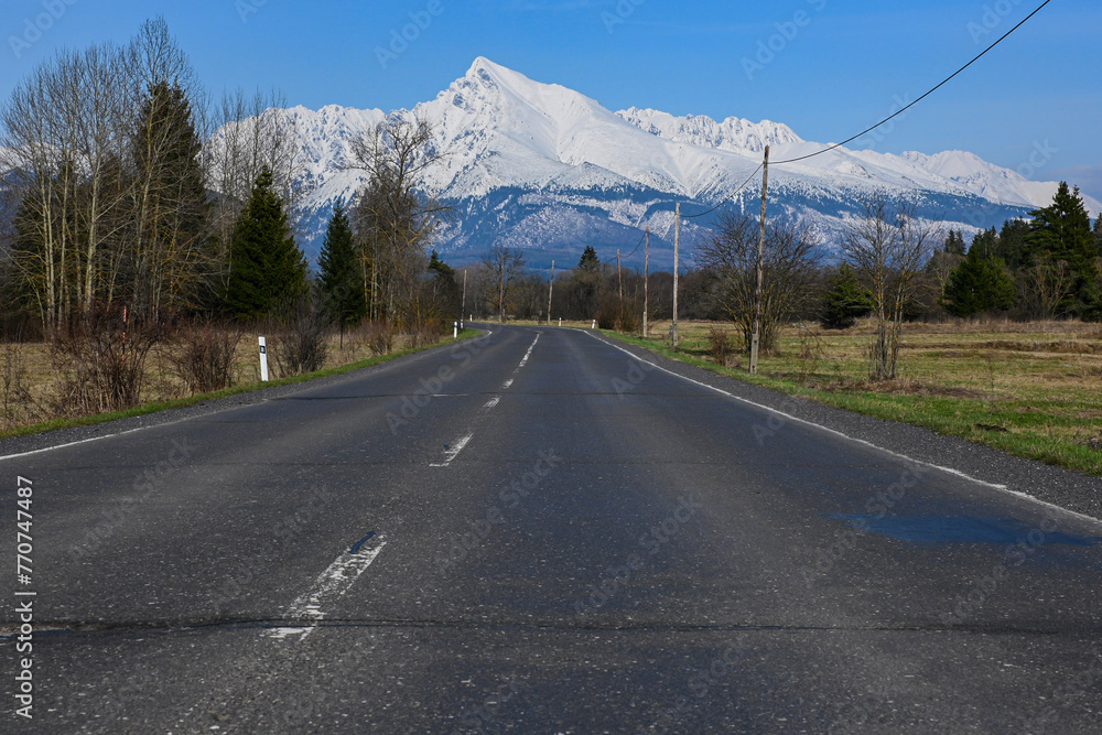 road with a view of the snow-covered mountains (High Tatras - Krivan) road with a view of the snow-covered mountains (High Tatras - Krivan)