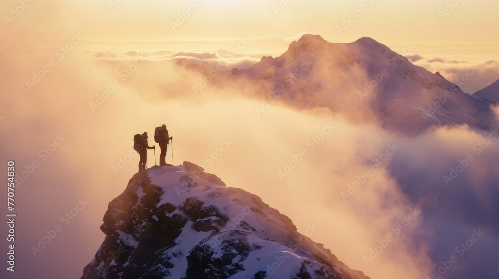 Two hikers help each other standing on tip of mountain top in winter in rugged lands with snow and majestic view. Two hikers help each other standing on tip of mountain top in winter in rugged lands with snow and majestic view.