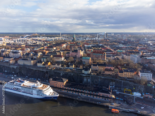 Aerial view of Stockholm, Södermalm district. Cruise ship, Katarina church, Globen and historical buildings after a rainstorm, early spring. Sunshine, partly cloudy. Commuter boat at dock on the sea photo