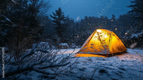 Tent in snow field in winter at campsite in rugged land.