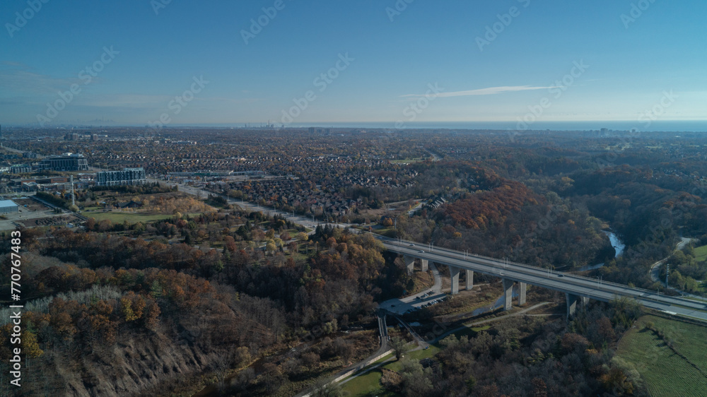 An aerial view at sunrise of a bridge going over a valley and River