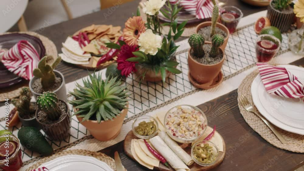 Top pan no people shot of beautiful festive table with traditional Mexican cuisine food - chalupa, fajita, burrito, nachos, tacos, guacamole, salsa, chilli, prepared for Cinco de Mayo celebrationTop p Top pan no people shot of beautiful festive table with traditional Mexican cuisine food - chalupa, fajita, burrito, nachos, tacos, guacamole, salsa, chilli, prepared for Cinco de Mayo celebrationTop p
