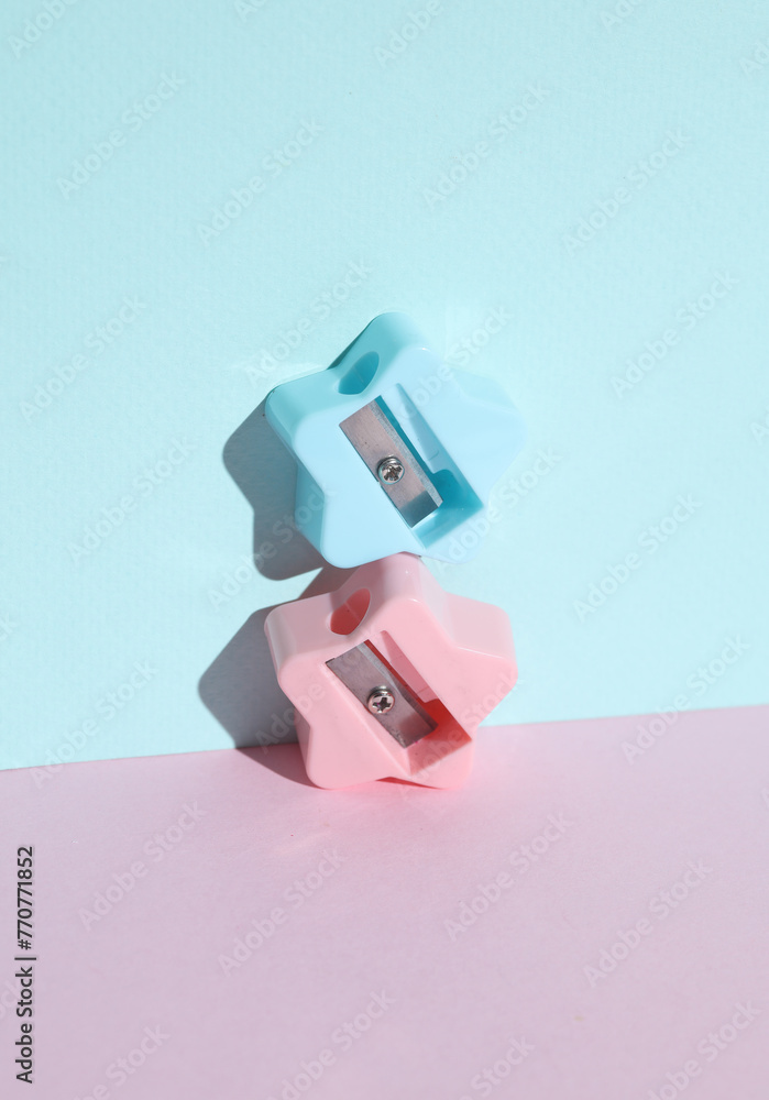 Sharpeners in the shape of stars on a blue-pink pastel background Sharpeners in the shape of stars on a blue-pink pastel background