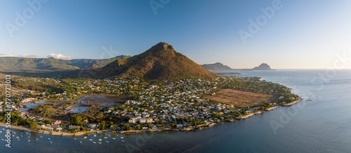 Aerial view of Tamarin village and marina with blue ocean and Le Rempart mountain, La Tourelle hill, and residential neighborhood, Riviere Noire, Mauritius. photo