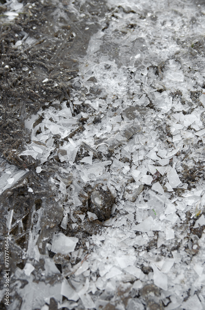 broken white ice on the ground in winter broken white ice on the ground in winter