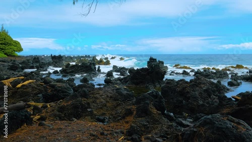 Wallpaper Mural Establishing shot of black lava rocks beach at Keanae Penisula in Maui island, Hawaii. A view of ocean waves splashing on black lava rocks. Cloudy day at the volcanic beach. Torontodigital.ca