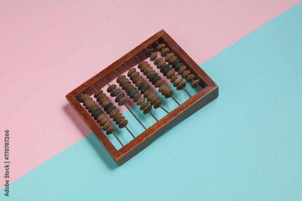Retro wooden abacus on blue pink background Retro wooden abacus on blue pink background