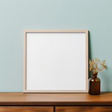 Empty minimal picture frame mockup with simple plant in vase
