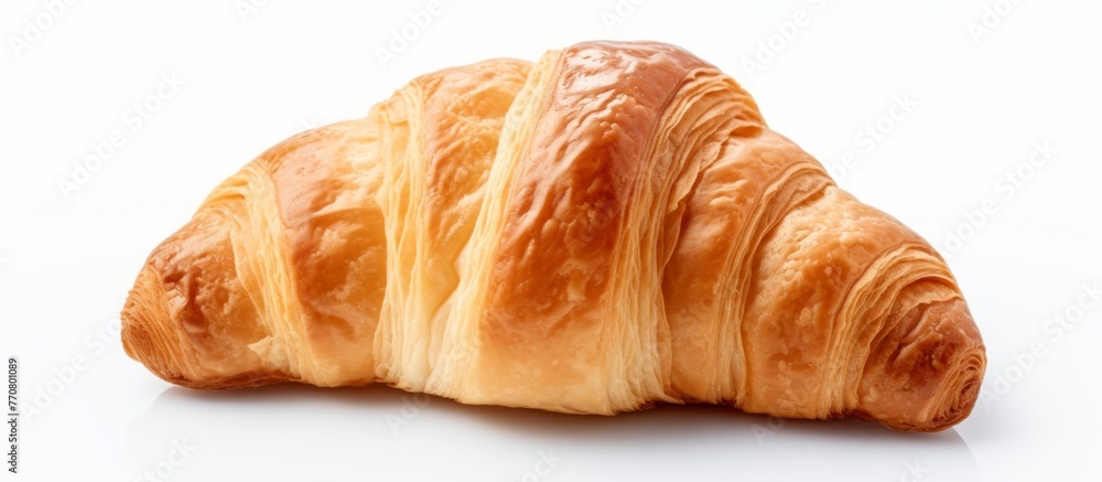 A close up of a croissant, a popular baked good in French cuisine, on a white background. This flaky pastry is made with ingredients like flour, butter, and yeast