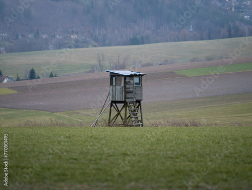 Принти на полотні Hunting stand or high seat for hunters in a rural landscape with agricultural fields