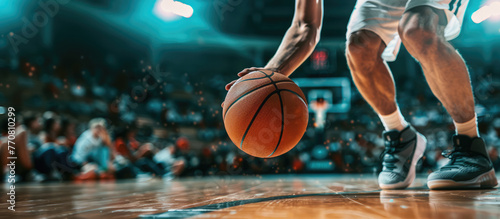 Basketball player is holding basketball ball on a court, close up photo   © DELstudio