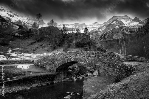 Sunset over the Pyrenees mountains, Circus of Gavarnie and the old stone bridge spanning the stream, High quality photo photo
