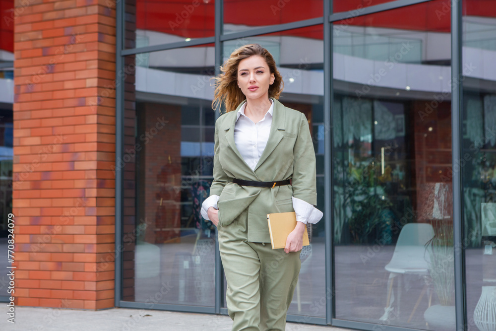 Portrait of a successful business woman in front of modern business building.Young manager poses outside. Female business leader.
Portrait of a successful business woman in front of modern business building.Young manager poses outside. Female business leader.