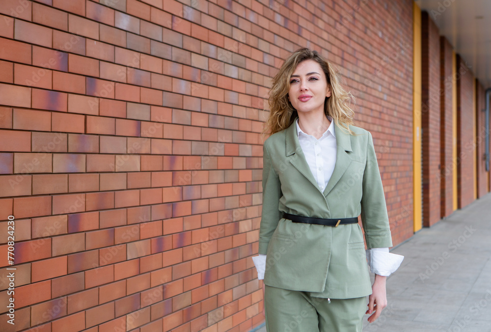 Portrait of a successful business woman in front of modern business building.Young manager poses outside. Female business leader.
Portrait of a successful business woman in front of modern business building.Young manager poses outside. Female business leader.