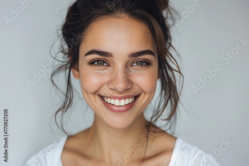 Woman In White. Young Beautiful Woman Smiling Happily for Portrait