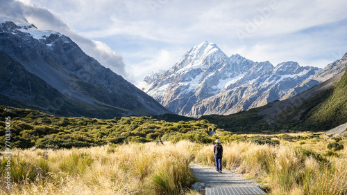 Wallpaper Mural Tourists walking the trail in beautiful alpine valley with huge snowy mountain, Mt Cook, New Zealand Torontodigital.ca