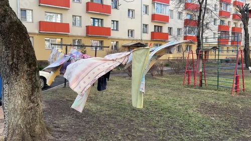 Breezy Laundry Day: Clothes Swinging on Outdoor Clothesline