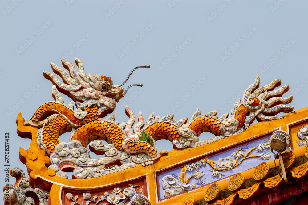 Fototapeta premium Detail Of Ceramic Dragon On The Roof Of A Palace In Hue Imperial Citadel, Vietnam.