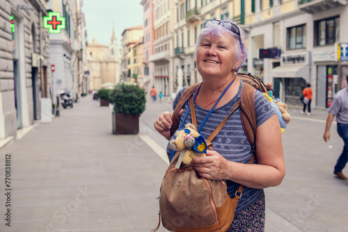 An elderly woman travels through Europe.