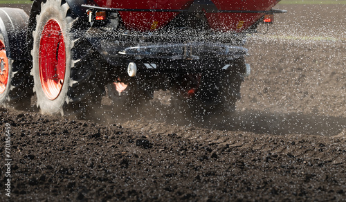 Fotografía Tractor spreading artificial fertilizers