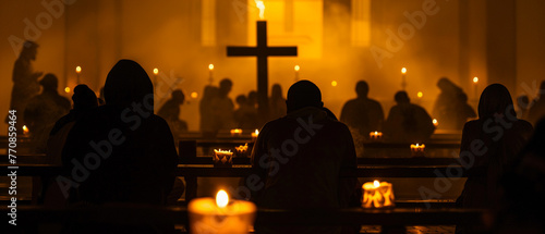 Silhouette of worshipers illuminated by candlelight photo