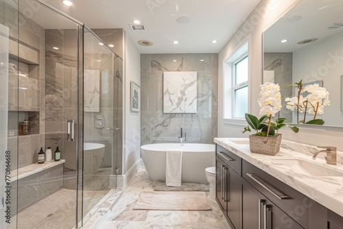 A high-angle shot of a luxurious bathroom featuring a freestanding bathtub, rainfall shower, and marble sink