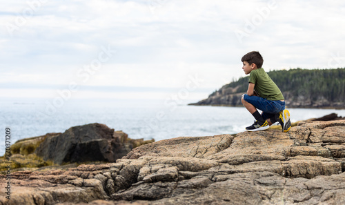 child exploring on Maine coastline