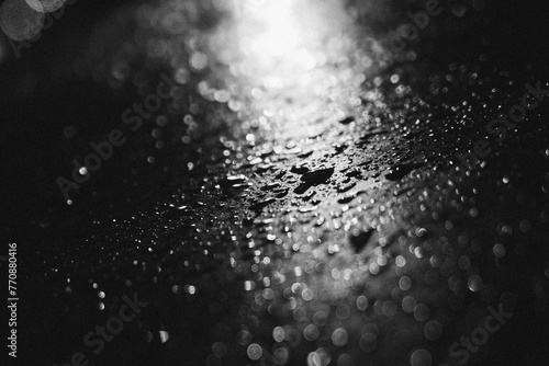 drops of water in black and white cinematic moody, iluminated by a streetlight photo