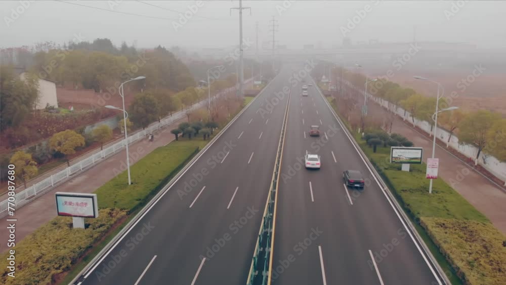 Aerial shot of a 6-lane street with cars passing by in Yiwu. Aerial shot of a 6-lane street with cars passing by in Yiwu.