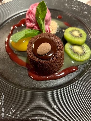 Chocolate cake with strawberry ice cream and fruits