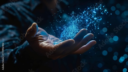 Open hand with sparkling blue digital particles. Concept of cyber space, virtual reality, and futuristic technology for creative background design.