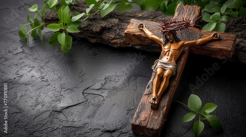  A wooden crucifix atop a black table, nearby, a tree branch lush with leaves