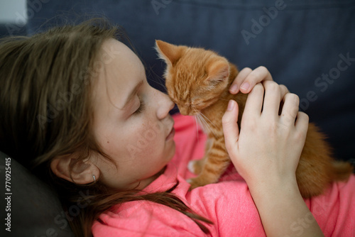 a girl with a red kitten photo